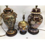 THREE VINTAGE EASTERN TABLE LAMPS DECORATED WITH FIGURES AND FLOWERS WITH WOODEN BASES