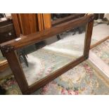 A HEAVY VINTAGE MAHOGANY MIRROR WITH FLUR DE LYS ON EACH CORNER