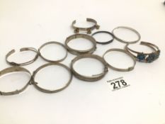 ELEVEN OLD SILVER AND WHITE METAL BANGLES