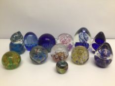 A COLLECTION OF UNMARKED GLASS PAPERWEIGHTS