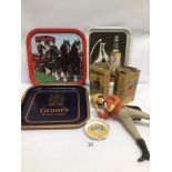 A VINTAGE COLLECTION OF BREWERIANA INCLUDING A JOHNNIE WALKER FIGURE, TIN TRAYS, BOTTLES, AND MORE