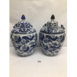 A PAIR OF CHINESE BLUE AND WHITE VINTAGE LIDDED URNS DECORATED WITH FROGS, CHARACTER MARKS TO BASE