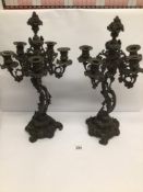 A PAIR OF BRONZE ROCOCO FRENCH FIVE BRANCH 19TH CENTURY CANDELABRAS DECORATED WITH VINE LEAVES AND