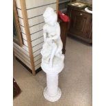 A CHINA SEATED FIGURE ON A CHALK PEDESTAL BASE 121CM