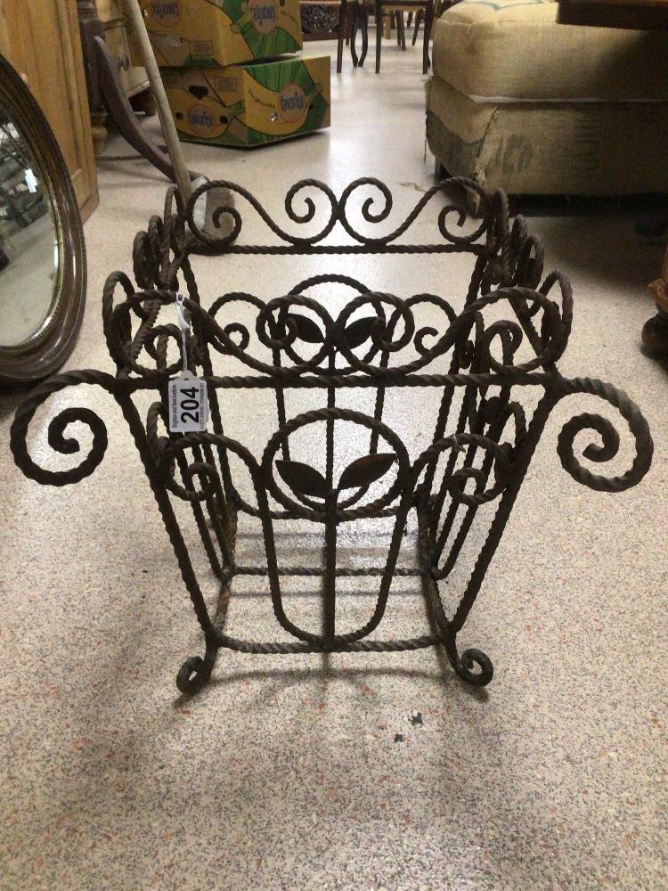 A VINTAGE WROUGHT IRON BASKET DECORATED WITH LEAVES