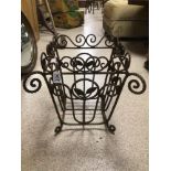 A VINTAGE WROUGHT IRON BASKET DECORATED WITH LEAVES