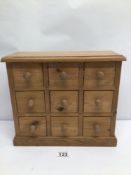 A VINTAGE SMALL (NINE DRAWER) PINE APOTHECARY CHEST LABELLED 'EASTFIELD WOODWORKS' APPROX 34 X 29CM