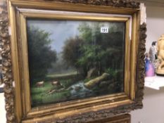 A 19TH CENTURY FRAMED AND GLAZED OIL ON CANVAS COUNTRY SCENE WITH GRAZING CATTLE IN GILDED FRAME