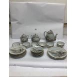 A JAPANESE EGGSHELL PORCELAIN TWENTY-THREE PIECE TEA SET WITH DECORATED WARRIOR LANDSCAPES