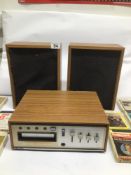AN AMEREX STEREO 8 TRACK PLAYER WITH TWO SPEAKERS AND MULTIPLE TAPES