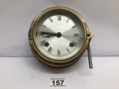 A VINTAGE BRASS NAUTICAL SHIPS WALL CLOCK IN W/O WITH KEY