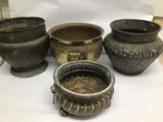 FOUR VINTAGE BRASS AND COPPER POTS TWO WITH LION HEADS HANDLES AND ONE WITH A MIDDLE EAST MOTIF,