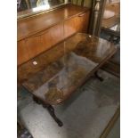 AN INLAID WALNUT COFFEE TABLE WITH GLASS TOP ON CARVED LEGS