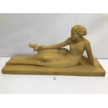 AN ART DECO STYLE SCULPTURE OF A RECLINING WOMAN AND A DOG SIGNED 'MELANI' (SOME LETTERS