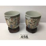 TWO SMALL CHINESE PORCELAIN HANDPAINTED TEACUPS ON WOODEN STANDS, 6CM