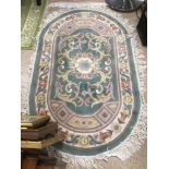 A VINTAGE OVAL WOOL RUG, 150 X 92CM