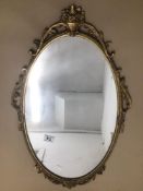 A VINTAGE GILDED OVAL WALL MIRROR APPROX 67 X 40CM