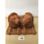 A PAIR OF TERRACOTTA SEATED LIONS 23 X 16CM