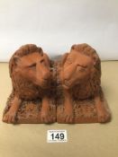 A PAIR OF TERRACOTTA SEATED LIONS 23 X 16CM