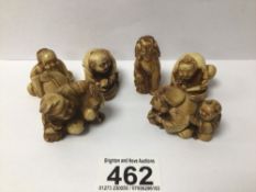 SIX CARVED RESIN FIGURES OF PEOPLE SEATED AND DOG OF FOO