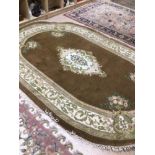 A LARGE OVAL RUG 296 X 204CM