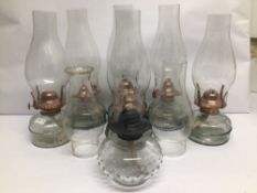 A COLLECTION OF SEVEN VINTAGE COPPER AND GLASS MINI OIL LAMPS, TALLEST IS APPROX 31CM