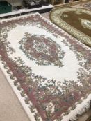 A LARGE WOOL RUG MADE IN INDIA 284 X 182CM