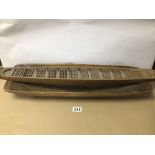 AN EARLY WOODEN DOUGH TROUGH WITH A WOODEN DART MODEL BOAT, 64CM LONG