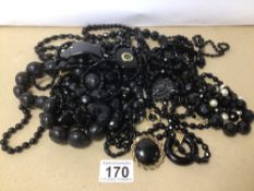 A VINTAGE BOX OF BLACK COSTUME JEWELLERY WITH JET