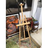 A WOODEN QUANTUM AND ART EASEL