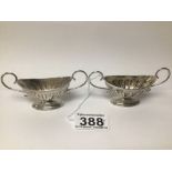 A PAIR OF HALLMARKED SILVER TWIN HANDLED BOAT SHAPE PEDESTAL SALTS, DATED 1895, LONDON TOTAL
