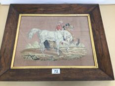 A VINTAGE FRAMED AND GLAZED SAMPLER WITH GILDED BORDERS OF A MIDDLE EASTERN MAN WITH TWO PRANCING