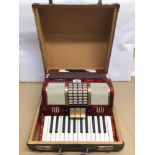 A CASED BELL FORTY-EIGHT BASS THREE COUPLER PIANO ACCORDION