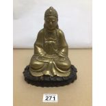 A VINTAGE BRASS BUDDHA ON WOODEN STAND 23CM