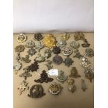 A COLLECTION OF VARIOUS MILITARY CAP BADGES