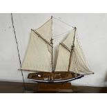 A VINTAGE MODEL SAILING BOAT ON STAND