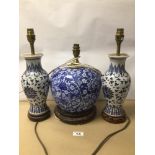 THREE BLUE AND WHITE PORCELAIN TABLE LAMPS, DECORATED WITH FLOWERS ON WOODEN BASES, OF WHICH TWO ARE