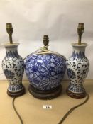 THREE BLUE AND WHITE PORCELAIN TABLE LAMPS, DECORATED WITH FLOWERS ON WOODEN BASES, OF WHICH TWO ARE