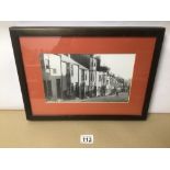 A FRAMED AND GLAZED BLACK AND WHITE POSTCARD OF DEAN STREET, BRIGHTON 39CM X 28CM