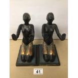 A PAIR OF RESIN KNEELING FIGURES AS BOOKENDS, 20CM