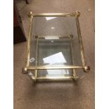 A VINTAGE BRASS AND GLASS TWO TIER TABLE 78 X 50CM