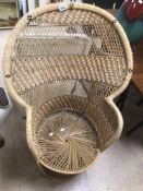 A VINTAGE PEACOCK CHAIR MADE FROM WICKER