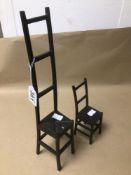 TWO CAST IRON MINIATURE LADDER BACK CHAIRS LARGEST BEING 38CM IN HEIGHT