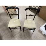 A PAIR OF EBONISED ITALIAN CHAIRS WITH GILDING DECORATION