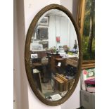 A VINTAGE BEVEL EDGED OVAL MIRROR, 46 X 70CM