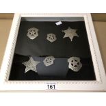 SIX REPRODUCTION UNITED STATES MARSHALL AND POLICE BADGES IN A WALL MOUNTED GLASS CASED DISPLAY