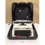 A CASED 1970S HERMES 305 WORKING TYPEWRITER WITH INSTRUCTION MANUAL