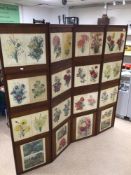 A VINTAGE WOODEN FOUR FOLD SCREEN DECORATED WITH VICTORIAN FLOWER PRINTS/ AND VICTORIAN DRESSWEAR