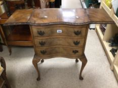 A VINTAGE CAMEO FURNITURE SERPENTINE FRONTED THREE DRAWER CHEST WITH EXTENDING LEAVES TO THE