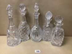 FIVE CUT GLASS DECANTERS WITH STOPPERS, INCLUDES ONE WATERFORD LARGEST BEING 35CM IN HEIGHT